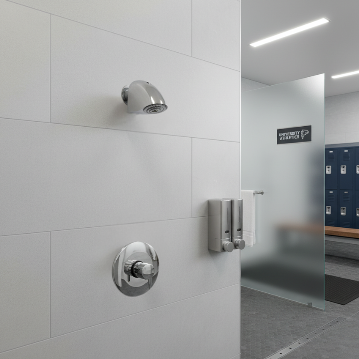 indoor push button shower valve with anti-ligature shower head in a high school gym locker room