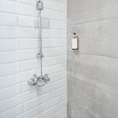 exposed indoor time and temperature adjustable shower valve with anti-ligature shower head at a resort / hotel